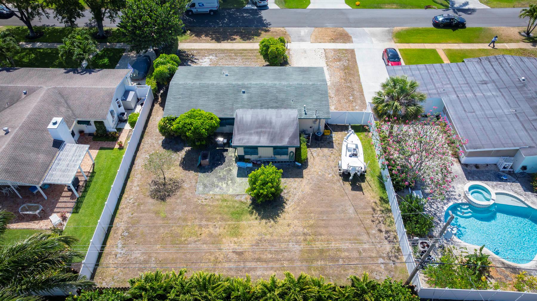 TOP NEIGHBORHOOD IN NORTHERN PALM BEACH COUNTY! This community is and has always been an amazing place to raise a family, retire to, or use as a second home. THIS HOME HAS SO MANY OPTIONS.... Update and enjoy this spacious yard, maybe add a pool. Update and expand this home creating your hearts desire. There is plenty of land to add onto this house. OR... Remove the current structure and create your dream home. The options are endless. Come take a look. This home is occupied. Please schedule an appointment to preview this property.