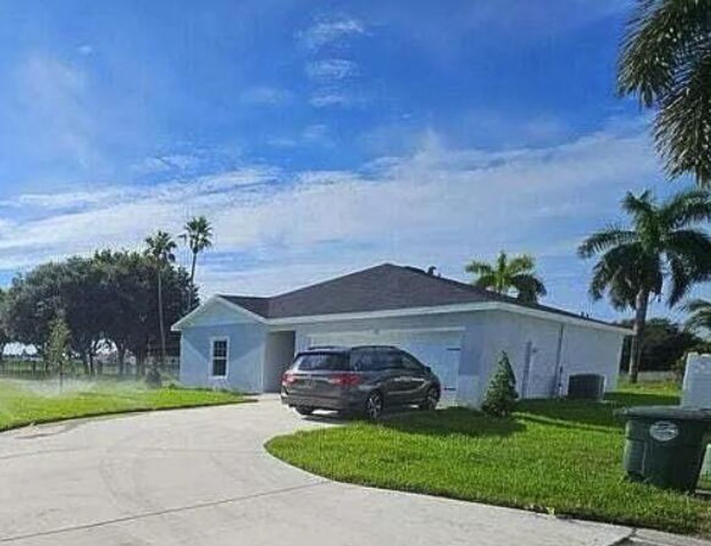 Photo of 136 Dabou Loop, Belle Glade, FL 33430 (MLS # R11146692)