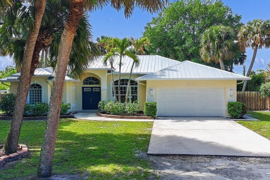 Set on a lush half-acre in Stuart, this lake side residence offers privacy, space, and an easy Florida lifestyle just minutes from downtown and the beach. This 3-bedroom, 2.5-bath home features a split floor plan, open kitchen, and durable flooring throughout, creating a comfortable and welcoming layout. Vaulted ceilings and natural light brighten the living areas, while serene water views and tropical landscaping create a setting that feels like a park in the town. Enjoy a screened pool ideal for relaxing or entertaining. Additional highlights include a 2-car garage, ample storage, and a detached shed. Positioned on a quiet cul-de-sac east of US-1, this is a rare blend of location, land, and setting.