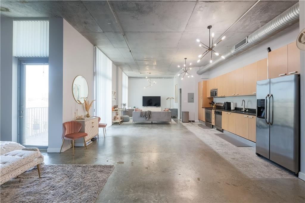Experience a vibrant urban loft-style in this stylish 2BR, 2BA. A truly modern living space featuring high ceilings and an open industrial design with concrete and tile flooring throughout. Oversized hurricane impact windows welcome ample natural light flowing in from an oversized balcony. Indoor space is anchored by a contemporary kitchen boasting stainless steel appliances and sleek cabinetry. The layout allows for versatility to maintain an open feel or add walls for privacy. Located just steps away from Downtown, cultural hubs, nightlife, I-95, and only minutes from our award-winning Broadwalk/beach. Enjoy a pet-friendly space, boutique pool, and designated parking in this lively mid-rise community. This is truly a walkable, affordable, So Florida condo lifestyle that is worth living!
