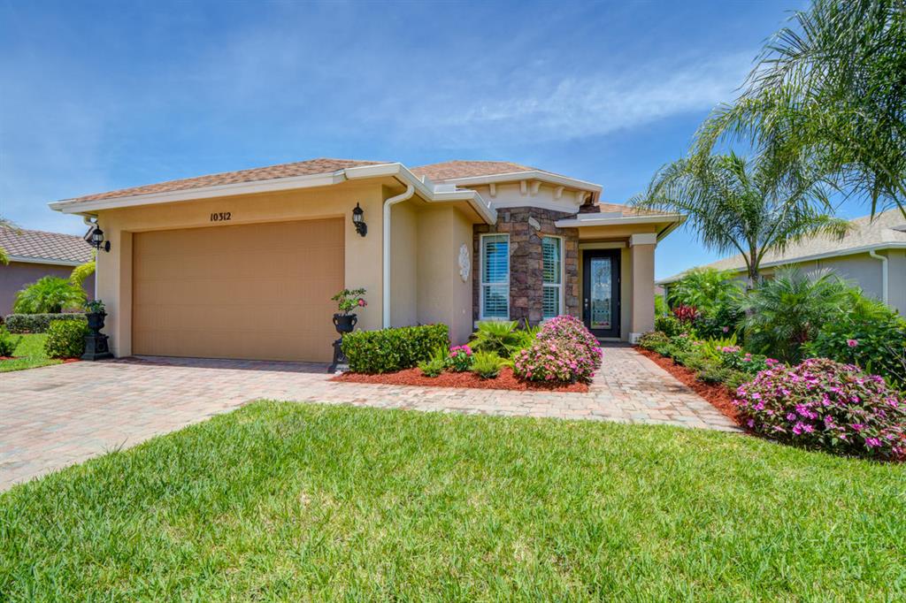 Stunning 2/2/2 home in Vitalia at Tradition! Upgrades Galore! High impact windows with plantation shutters. Professionally landscaped. Kitchen has breakfast bar, granite counters, pendant lights, SS appliances and large pantry. Cozy breakfast nook has volume ceiling. Dining Room features crown molding and ceiling medallion. Great Room has tray ceiling, built-in wall unit, ceiling fan and crown molding. 2nd BR features a built-in desk, overhead book case with under cabinet light and ceiling fan. Covered Lanai has sun shades overlooking tropical setting. Active 55+ community!
