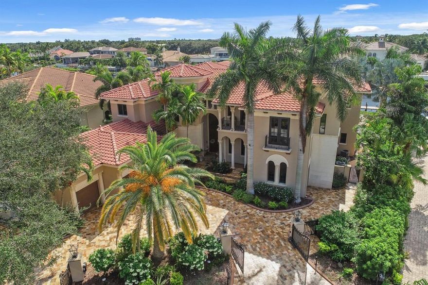 Stately waterfront estate home boasting 8,188 sq ft of luxury living space. Located in a quiet cul-de-sac in highly desirable Admirals Cove. Expansive water views & room for an 80 ft boat w/ direct access to the intracoastal and ocean within moments. A grand formal entrance & a custom ten-seat plush velvet theater are among the many comforts in this 5BR, 6BA custom home. State-of-the-art surveillance & exterior lighting. Pool & spa finished w/ Davinci stone pavers. This beautifully appointed estate built in 2005, has only the finest craftsmanship & materials, including impact glass & marble floors throughout.  Master suite boasts washer/dryer, breakfast bar with refrigerator, & balcony.  1st floor maids quarter w/ kitchen. Required golf membership conveys all the amenities of Admirals Cove