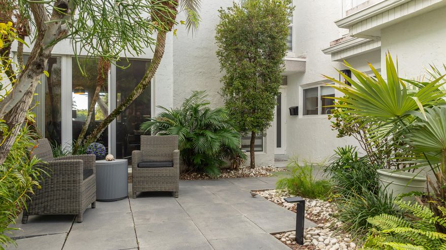 Discover this fabulous Wilton Manors Townhouse with water views, attached garage, spacious screened in patio,  beautifully landscaped courtyard ,updated kitchen , High impact windows and doors Plus accordion shutters offer storm protection in this tropical paradise.  Enjoy the community pool that over looks the river.  Located just few blocks from Wilton Drive makes it easy to enjoy all the restaurants, shops, galleries, and theaters .Take in the bustling night life while being able to retreat to your very own tranquil island of townhomes and tree lined streets. This is one of the areas best kept secrets.   Across the tiny bridge and down the block you'll find Hagen Park with Pickle Ball ,Tennis Courts , Volley Ball and much more.  15-20 minutes to the Beach. This is that Rare Gem that you just may fall in love with.