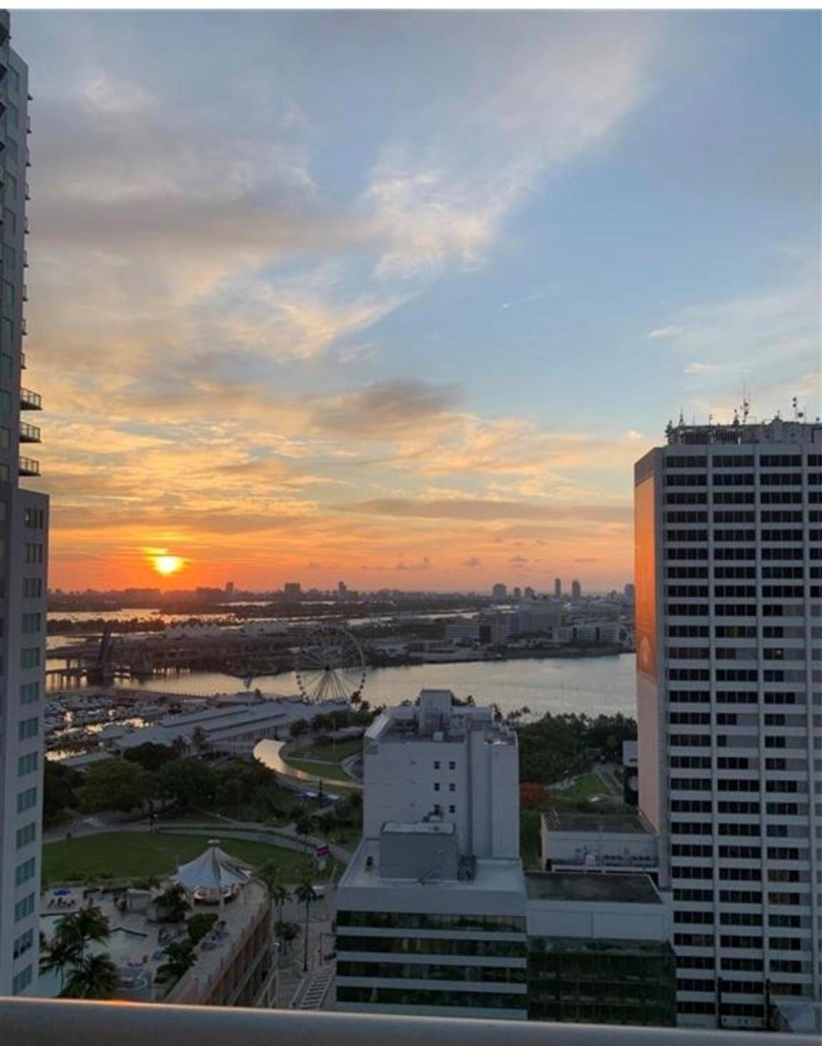 Experience urban living at its finest! This 2 bed, 2 bath apartment in Downtown Miami offers modern open space with 10-ft high ceilings and concrete floors. Italian kitchen cabinets, enclosed bedrooms, and stunning city and bay views add elegance. Enjoy rooftop pool and gym, ground-level lap pool, 24/7 security, and nearby dining and shopping. Amenities include water, internet, cable, and in-unit washer/dryer. Parking available for $65/month. Live the Miami lifestyle today!