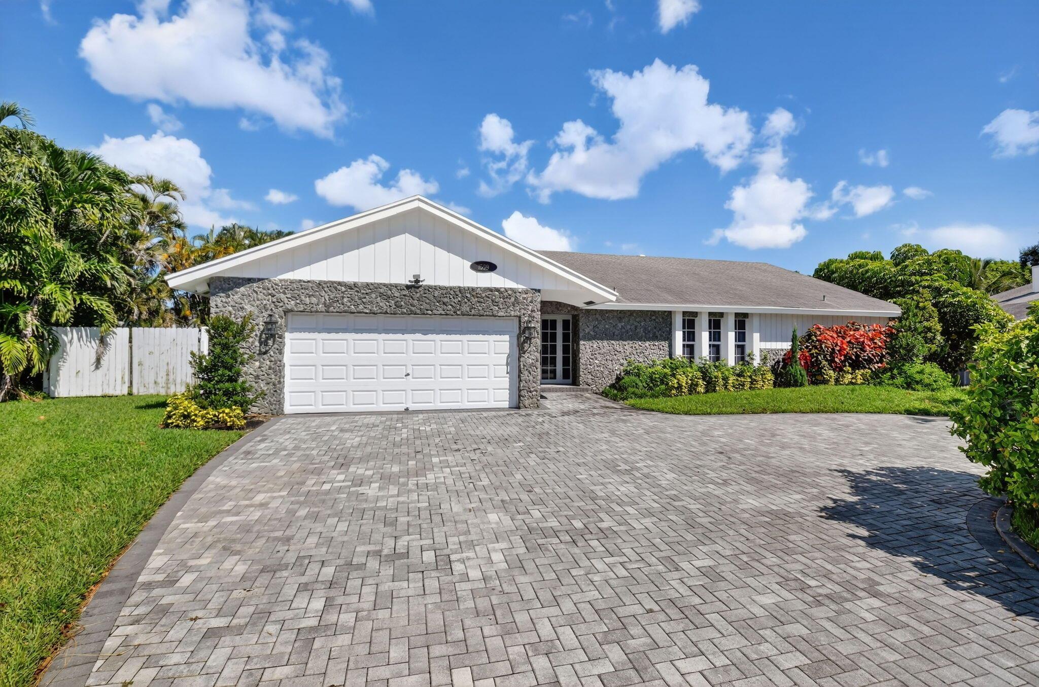 Experience the best of South Florida living in this 5-bedroom, 3.5-bath home offering nearly 3,000 sq. ft. of living space. Ideally located in the heart of prestigious East Boca Raton, you'll be just minutes from pristine beaches, world-class shopping at Town Center Mall, premier dining, and top-rated schools. Set on a sprawling half-acre corner lot, this residence provides ample space for all your needs. Step outside to your private backyard oasis featuring a sparkling pool, outdoor bar with TV, and built-in gas grill--perfect for entertaining or unwinding under the Florida sun. The expansive, fully fenced yard offers plenty of room for kids, pets, and play. Whether hosting lively gatherings or enjoying quiet evenings at home, this property perfectly blends comfort, size and location.