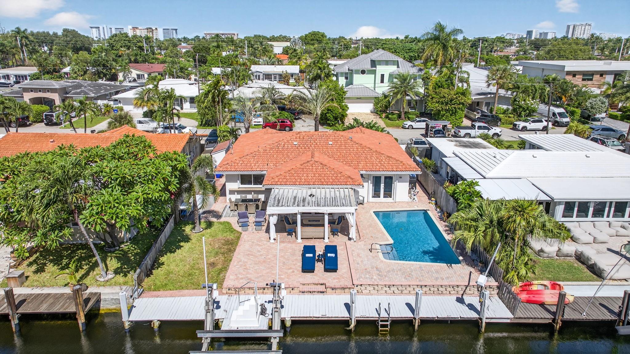 Direct Ocean Access pool home. 60 ft of waterfront. 14,000 pound boat lift, large dock. South facing pool area. 2 beautiful bedroom and baths. French doors lead to the large Cabana area. Inviting circular paver driveway. Marble flooring. Updated kitchen. Entertainers dream, complete with large bar to relax at with your friends. Bring your boat, kayaks, jet ski's, and enjoy the South Florida waterfront living! 1 block to Ft Lauderdale. Visit nearby Pompano Beach, one of the widest in Broward County. Control the sprinkler system, house lighting, and a/c from your smart phone or tablet. This easily converts to a 3 bedroom dream home. Travel down the street and see the amazing homes being built. Roof 2022, A/c 2021, seawall inspected/sealed 2024, pool resurfaced 2021.