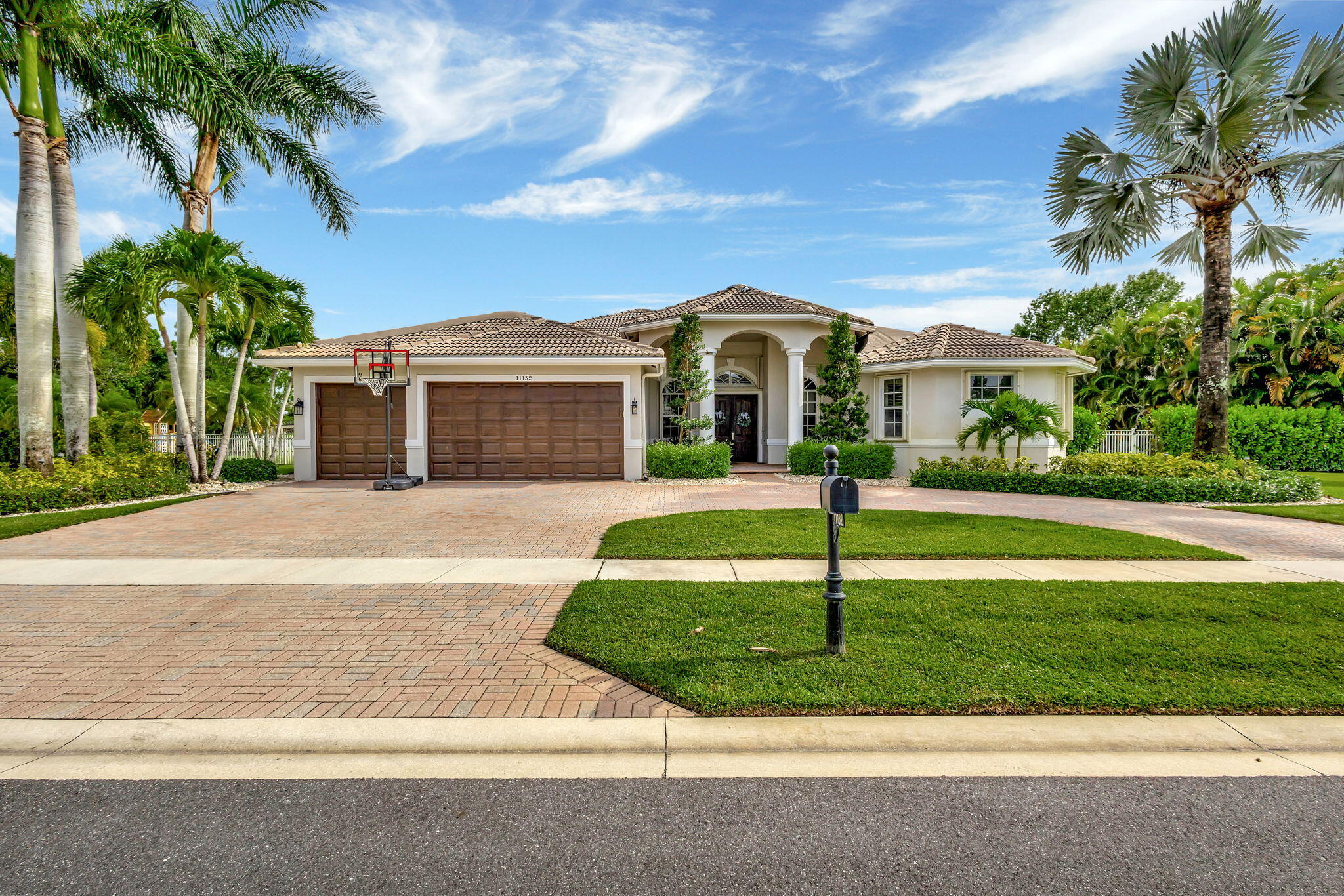 Welcome to your dream retreat! This stunning 5-bedroom, 3-bath home is the perfect blend of sophistication and comfort. Designed for today's lifestyle, it features an open layout filled with natural light, an updated kitchen flowing seamlessly into a spacious family room, and rich, beautiful colors throughout. Step outside to your private oasis on a fully fenced 1/2-acre lot with a large covered patio, sparkling heated pool, relaxing jacuzzi, and cozy fire pit--all overlooking a peaceful lake. Ideal for entertaining or unwinding in style. Nestled in a 24-man gated cul-de-sac community, just minutes from Winter Equestrian and Polo, with easy highway access and only 30 minutes to PBI. This is Florida living at its finest!