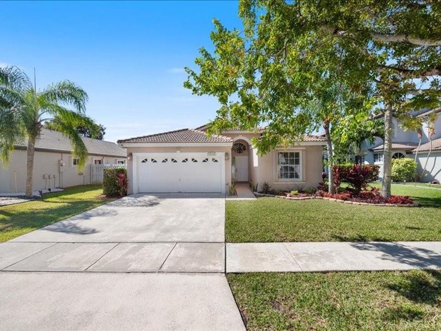 Stunning Move-In Ready Home in West Pembroke Pines! This spacious 5-bed, 2.5-bath home boasts an open-concept design. The modern kitchen features granite countertops, stainless steel appliances, and sliding doors leading to a fenced backyard perfect for entertaining! 1st floor convenience. Move in with confidence with a full house automatic generator, fresh interior paint, accordion shutters, brand new vanities in all bathrooms.  In home fire sprinklers. Located in Emerald Springs at Silver Lakes, a gated community with parks and picnic areas, this home offers the perfect blend of comfort, style, and convenience.