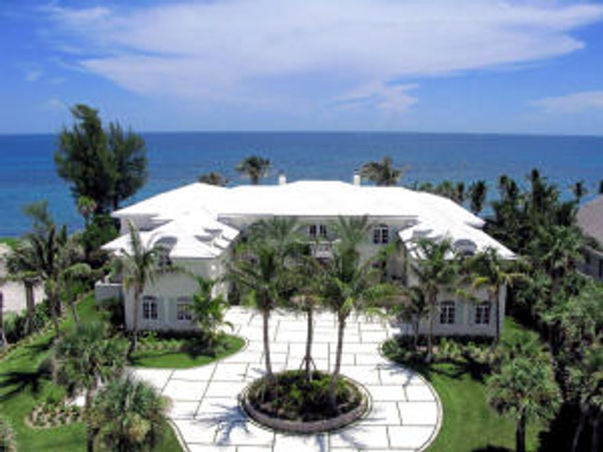 Elegance and panoramic views are abound in this Atlantic oceanfront estate at prestigious Sailfish Point. Wide balconies with slate floors and cypress ceilings afford an unparalleled view of the sandy beaches and sparkling Atlantic Ocean. The infinity edge pool is surrounded by slate decking with spill over spa. Enjoy casual al fresco dining and entertaining at the sit down bar area in the covered summer kitchen complete with stainless steel gas bar-b-que.  Marble floors grace the main living areas. Stain grade cypress trim and solid core birch doors are installed throughout the estate. 11,500 square feet of living space include six bedrooms, eight luxurious full bathrooms with whirlpool tubs and oversized showers, two half baths and an elevator to the second floor.