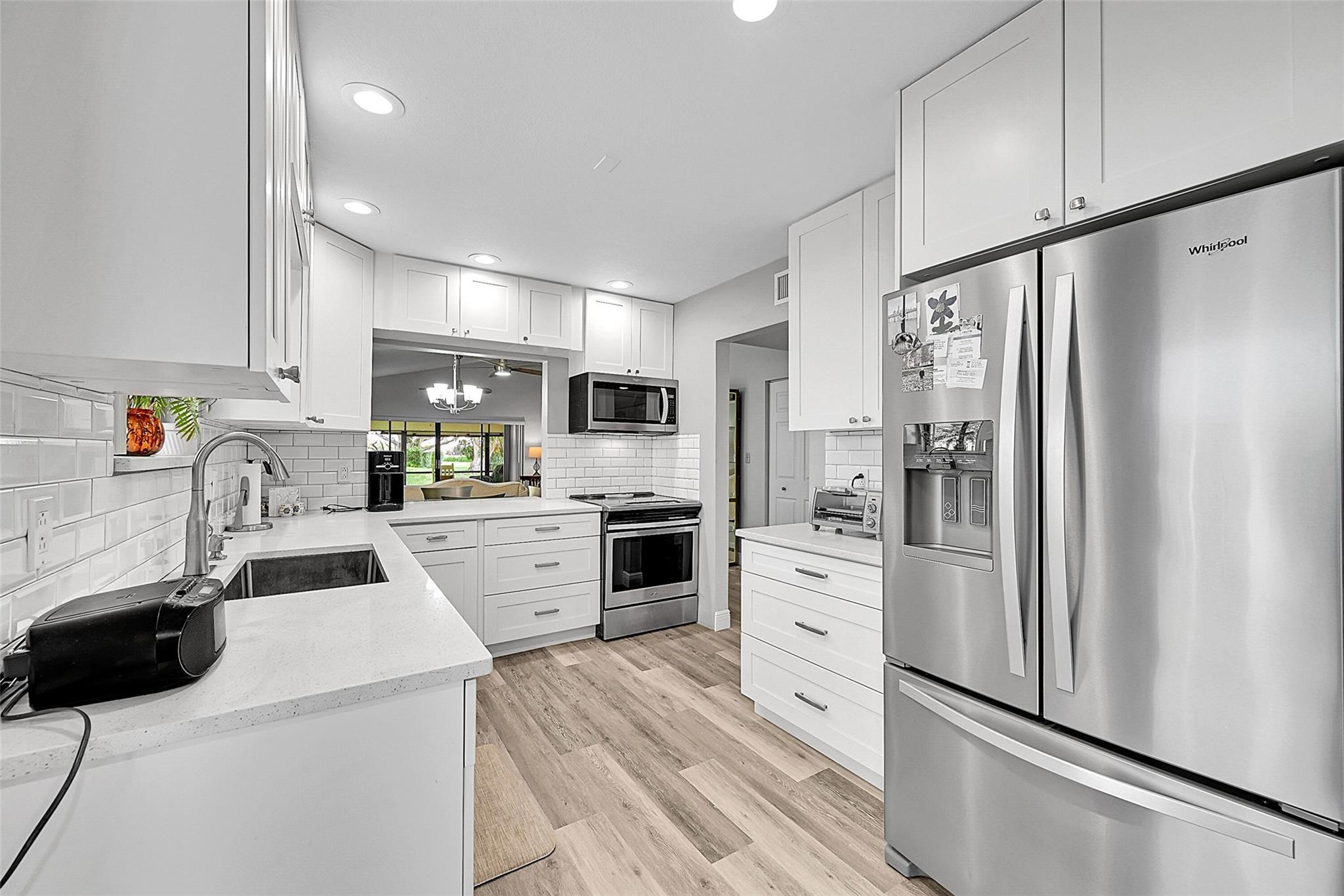 Enjoy turnkey living in this beautiful corner villa located in Lakeside of Bonaventure. This spacious 2-bedroom, 2-bathroom home offers an open living & dining area filled with natural light. The brand-new gourmet kitchen features stainless steel appliances & modern finishes. The oversized primary suite includes a fully renovated bathroom, abundant closet space, & sliding glass doors leading to a covered patio —an ideal place to enjoy both sunrise & sunset. A second bedroom opens to a private front courtyard, adding charm & flexibility for guests or a home office. Additional highlights include a covered carport with extra parking for up to two vehicles, accordion shutters, & in-unit washer & dryer. Zoned for top-rated schools & conveniently located near I-595, I-75, shopping, & dining.