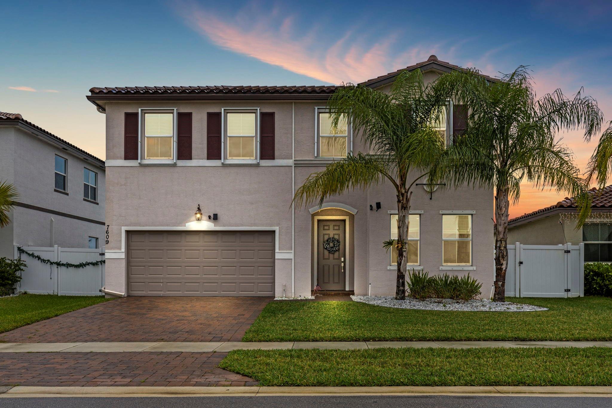 CREDITS TOWARDS CLOSING COSTS AVAILABLE! This stunning Copper Creek home checks all the boxes: Concrete Block Construction on both story's, fully fenced-in backyard (private), Gated Community which offers a clubhouse, pool, and a fitness center, a first-floor master suite showcasing a custom Japanese-style Shou Sugi Ban feature wall, engineered hardwood floors throughout main living areas, custom built-in bar, 4+ flex bedrooms, 3.5 bathrooms, loft, pavers in front and back, accordion shutters, and barrel tile roof. Just 2–3 miles away, the Jim Furyk Championship Golf Course opens to the public in summer 2025. The $600M Koa Bay Surf Park is 7.5 miles away, opening late 2026. Near Tradition (3 miles), enjoy Target, TJ Maxx, West End Grill, and Kilwins. Get in early to this booming area!