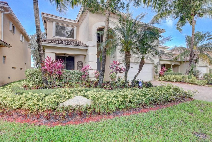 Home was that Builder's model and has all the upgrades and special options.  Spacious floor plan with additional loft / media area upstairs plus family and living rooms on the main floor.  Gourmet kitchen with granite counters and Inside laundry room. Office area located off the family room with model grade built ins. Gorgeous pool / patio over looking lake.  Multi-color rotating lights in pool plus a permanent waterfall.  Intercom system throughout which acts as a door chime and provides music - radio and DVDs.  Manned guard gate community with Clubhouse facilities including pool and exercise.  This home has it all in a central location in Palm Beach County.