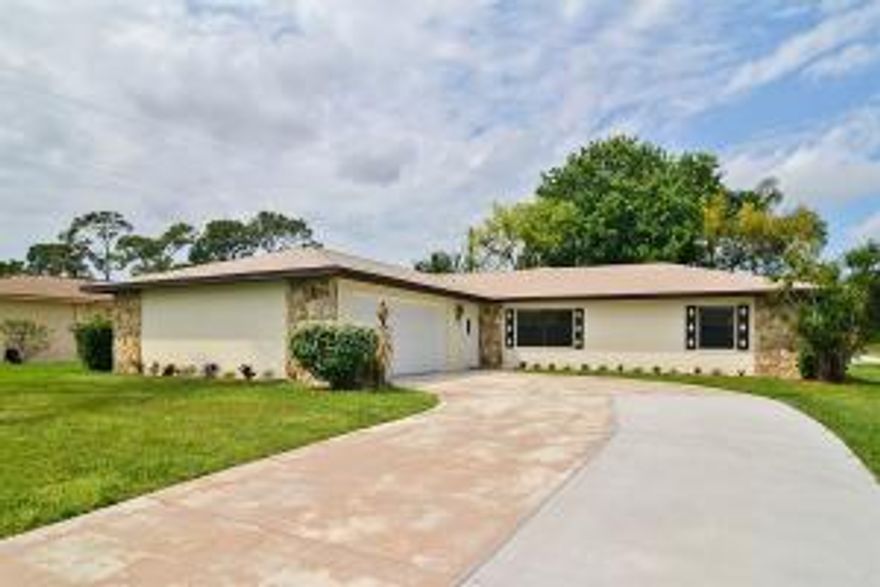 You've arrived home with this totally remodeled gem. CBS split plan lovingly updated from top-to-bottom. Features include 20'' tile in public spaces, granite kitchen with SS applicances, gorgeous cabinetry with passthrough to rear enclosed patio (27X12). Redone baths, 2 car garage with it's own 1/2 bath to use after working in the yard or in the garage. New garage door, newly painted inside & out. This home has public water & septic. Public sewers are available and can be connected at buyer's expense. This one's a winner-walk, don't run to check it out.