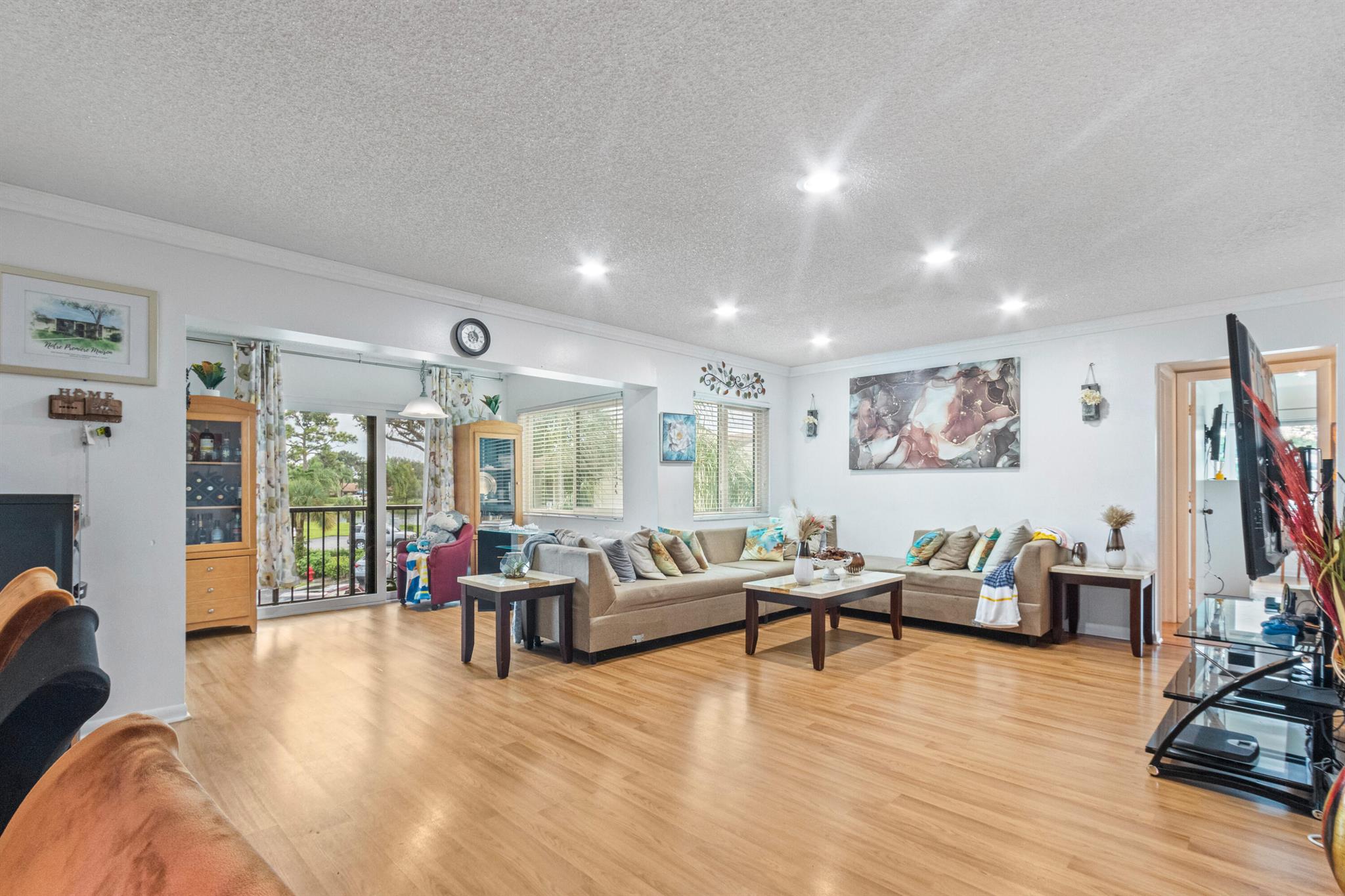 This spacious 2 BD, 2 BTH 1,115 sq. ft condo is located on the 2nd floor in the desirable community of Pine Ridge North I in Greenacres. This beautifully maintained unit offers an open floor plan, updated kitchen w/ stainless steel appliances, wooden plank flooring throughout, and a private screened balcony. The community features amenities such as a pool, clubhouse, and jogging/walking paths. Centrally located near shopping, dining, parks, PBI Airport & FL Turnpike. Ideal for those seeking a comfortable, low-maintenance lifestyle in a great & lovely neighborhood.