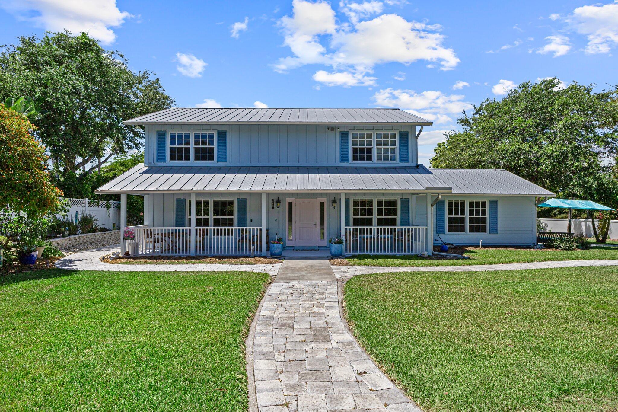 Welcome to your new tropical oasis. Nestled in an intimate 6-lot subdivision, East of A1A , this spacious 4-bedroom, 3-bathroom two-story home offers the perfect blend of comfort, style, and coastal charm. House completely renovated in 2018, master bedroom en suite upstairs, metal roof, enjoy sunsets on your expansive deck (16x11). Just a short drive to local shops, dining, theater and more. Short walk to the neighborhood's pristine beach.