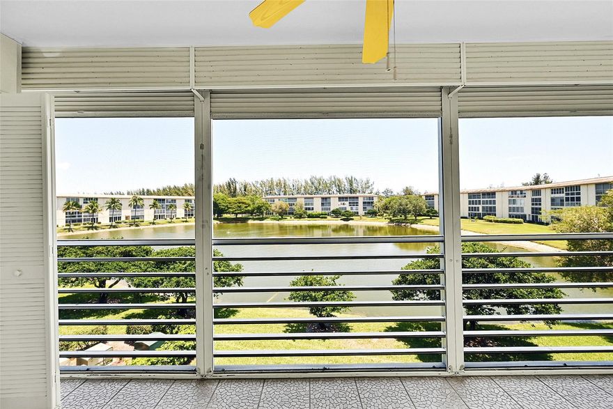 You will be pleasantly surprised when you enter this condo featuring all vinyl and laminate flooring. The updated kitchen boasts granite countertops and has been professionally painted, making it move-in ready. The air conditioning system is newer, installed in 2021. Enjoy a panoramic wide water view with a fountain, especially lovely in the evening when the fountain is illuminated. The large eat-in kitchen is equipped with updated appliances. Be sure to check out all the photos, and then see the condo for yourself. This floor plan includes the largest patio in all of Wynmoor.