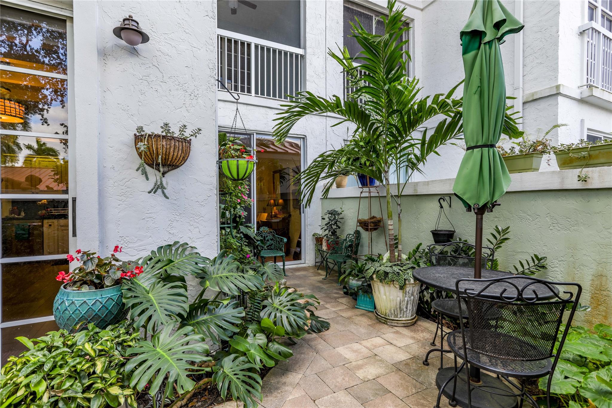 The feeling of a single family home with the security of living in a condo. Perfect first floor unit with a private and charming outdoor garden. Patios enclosed with glass increasing living space. Primary and office/third bedroom face golf course. Secondary bedroom has sitting area and access to private garden. Spacious primary bedroom has a large walk-in closet while the bath features dual sinks, Roman tub and separate shower. Wet bar in family room. Interior laundry room with a full sized washer & dryer. One covered parking space and ample guest parking. Plenty of closet space and a storage room. Gated community with secured lobby. Additional entrance from private garden. Clubhouse and heated pool is just a short walk from unit.