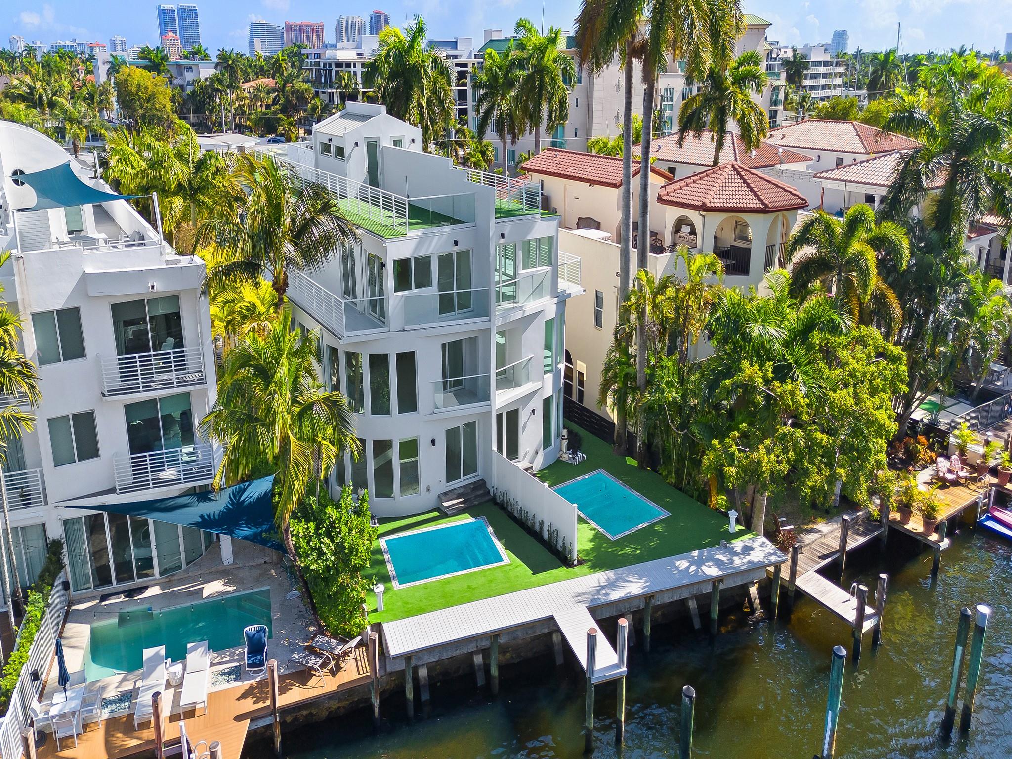 NEW WATERFRONT TOWNHOME situated in Ft. Lauderdale's Las Olas Isles. Contemporary design, modern conveniences, deep water dockage & no fixed bridges to the ocean. A luminous flr plan, flr to ceiling walls of glass & open concept living spaces. Access flrs 1-3 in a glass elevator or by the floating staircase & glass railing. The 1st flr offers a waterside great rm (or optional bedrm) a wet bar, full bathrm & access to a lrg pool & dockage for a 30' vessel. The 2nd flr boasts an open kitchen, a gas cooktop & upgraded appliances, dining area, family room & VIP ensuite bedrm. The 3rd flr waterside primary bedrm w/a lavish bathrm & 4th bedrm w/a pvt. bathrm share a large open balcony. The roof top terrace is outfitted for a future summer kitchen, jacuzzi & generator. Sq ft from developer.