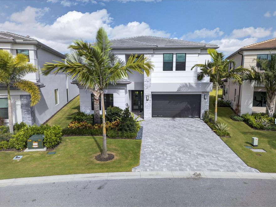 Experience modern luxury in this stunning Polynesia model located in the exclusive Lotus Edge community in Boca Raton. This impressive 5-bedroom, 7-bathroom residence, blends contemporary design with functional elegance. The spacious open layout features a gourmet kitchen with designer finishes, large living and dining areas, and a versatile upstairs loft. The primary suite offers a serene retreat with a spa-like his and hers bathroom and generous closet space. Impact windows, smart-home technology, and high-end finishes elevate the home's appeal. Residents enjoy access to resort-style amenities and a vibrant gated community, just minutes from top-tier dining, shopping, and beaches.