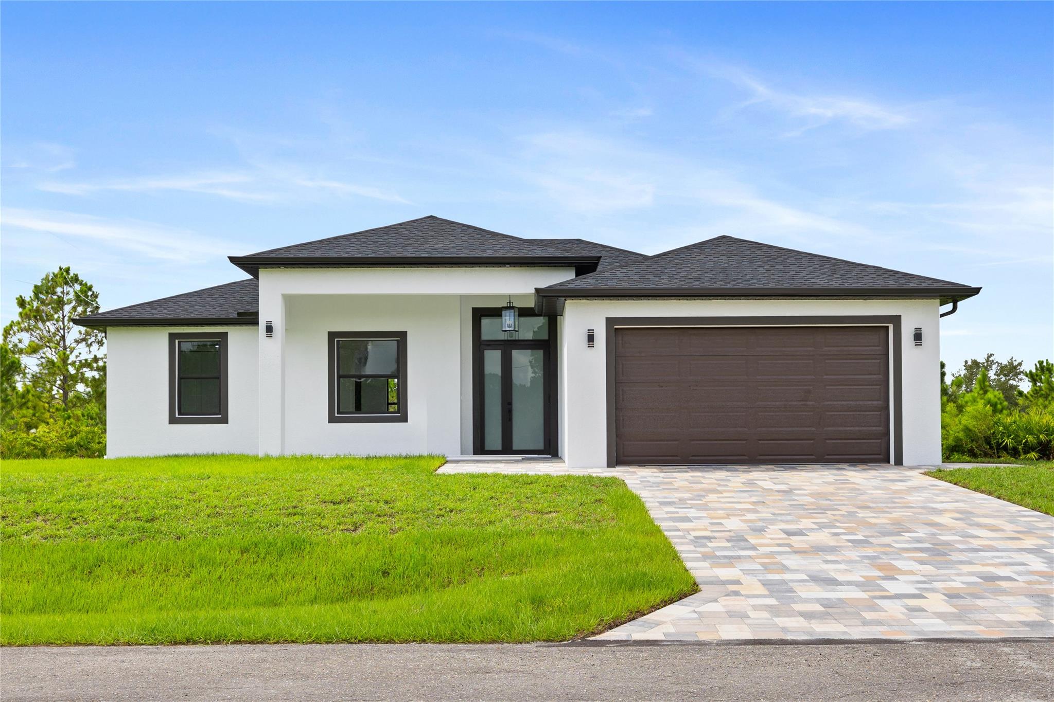BRAND NEW CONSTRUCTION! This is the home you have been looking for. Featuring an ample floor plan with 4 bedrooms and 3 FULL baths. The kitchen offers European-style modern matte-anti fingerprints cabinets, quartz countertops, stainless steel appliances, and a large waterfall island with snack bar seating. Bathrooms are beautifully finished, and all closets have custom shelving. Enjoy high 10-foot ceilings, tall doors, and impact windows and doors for peace of mind. Porcelain tile floors and energy-saving LED lighting throughout. Covered and tiled Lanai area and welcoming front entrance with anti-slip porcelain, and pavers in driveway. Epoxy finish 2-car garage and separate laundry room with full-size washer and dryer. Move-in ready and perfect for those looking for comfort and quality!
