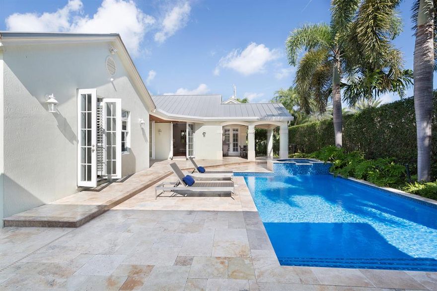 Attuned to indoor/outdoor living, this casually elegant Bermuda-inspired compound features a newly expanded main house and a separate guest cottage across the pool courtyard in this palm-studded oasis just a couple blocks from the beach, near Atlantic Avenue. Perfect for entertaining, the versatile layout features a bright, spacious living room with lofty vaulted ceiling. Luxurious master suites are on both levels.            See More for Disclaimer