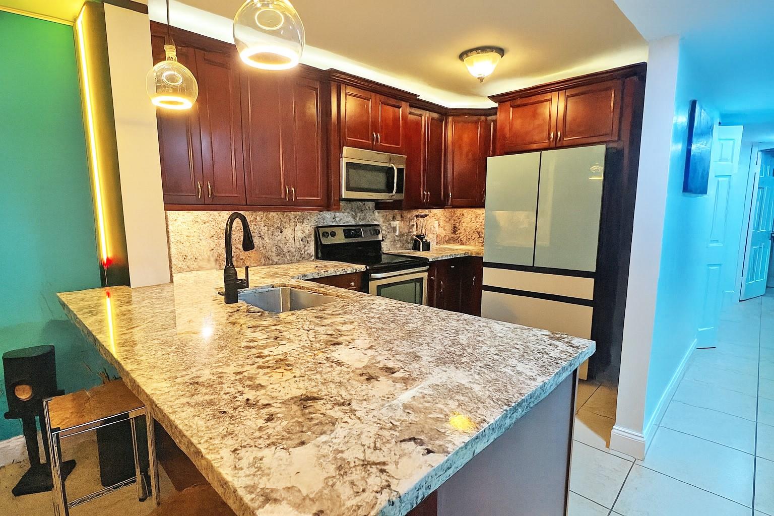 ***Unique opportunity*** A True 3 bedroom, 2 bath first floor unit with all the bells and whistles!! Stunning upgraded kitchen featuring above + under cabinet lighting, a brand new top of the line refrigerator, stainless steel appliances and gorgeous natural stone countertops.. 2024 A/C!!! Washer & Dryer inside the unit! Mature trees shade the patio and the lush grounds overlooking the canal. Plenty of room to walk the dogs!! Upgraded granite bathrooms!! Tile floors throughout.. no carpet!! Quiet community with all the amenities including a BBQ/picnic area, clubhouse-clubroom, and a massive pool. NO CREDIT SCORE REQUIREMENT. Middle & High Schools are MAGNET SCHOOLS!! Quick access to I-95 and the Turnpike.. Short drive to the beach!!