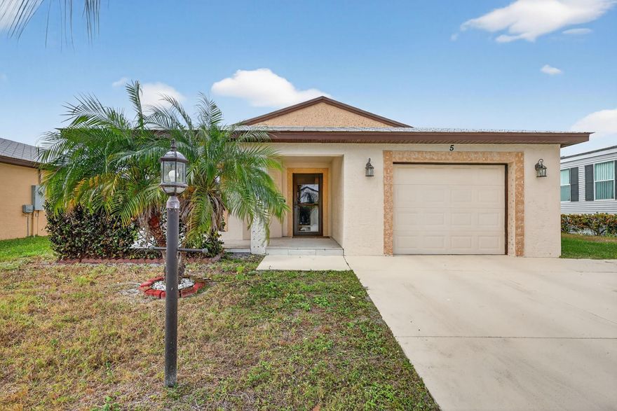 Well maintained single family home in the sought after 55 plus Spanish Lakes One community. This lovely home features 2 large bedrooms. Laminate floors in living areas and both bedrooms. Kitchen has granite countertops, backsplash and stainless steel appliances. Master bathroom has dual sinks and huge walk-in closet. Both bathrroms have bath fitters. Inside utility room with full size washer-dryer. Knockdown walls and ceilings. Metal roof. CBS construction. Huge screened patio. 1 car garage with 3 car driveway. Peaceful neighborhood. Lot rent covers all amenities, lawn care ,trash removal and sewer. Active lifestyle with resort amenities which include full calendar of activities, clubhouse, 2 pools, tennis, pickleball, fitness center and more. Great location close to shopping. Shows great.