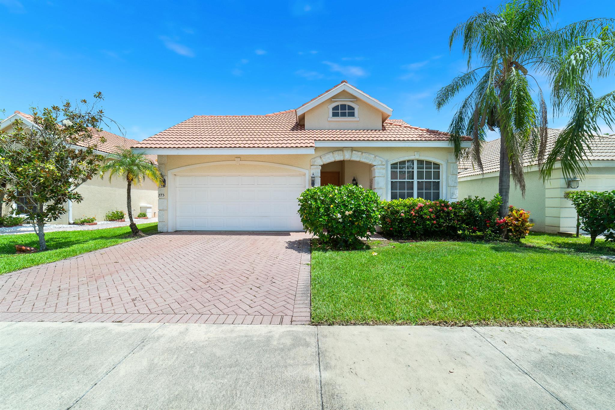 Welcome to this truly unique Courtyard Pool Home nestled in the highly sought-after gated community of Lake Charles in St. Lucie West. This residence offers a modern and inviting atmosphere with an open contemporary floorplan and soaring ceilings that create a light and spacious feel throughout.The heart of the home surrounds the in-ground pool, offering views and access from the main living areas including the expansive primary suite, living room, second bedroom, and kitchen, ideal for indoor-outdoor living and entertaining. The third bedroom features sliding doors that open to a serene garden view, providing a quiet retreat.One of the standout features of this home is the detached studio suite complete with a full bathroom and direct pool access. Whether you need a home office