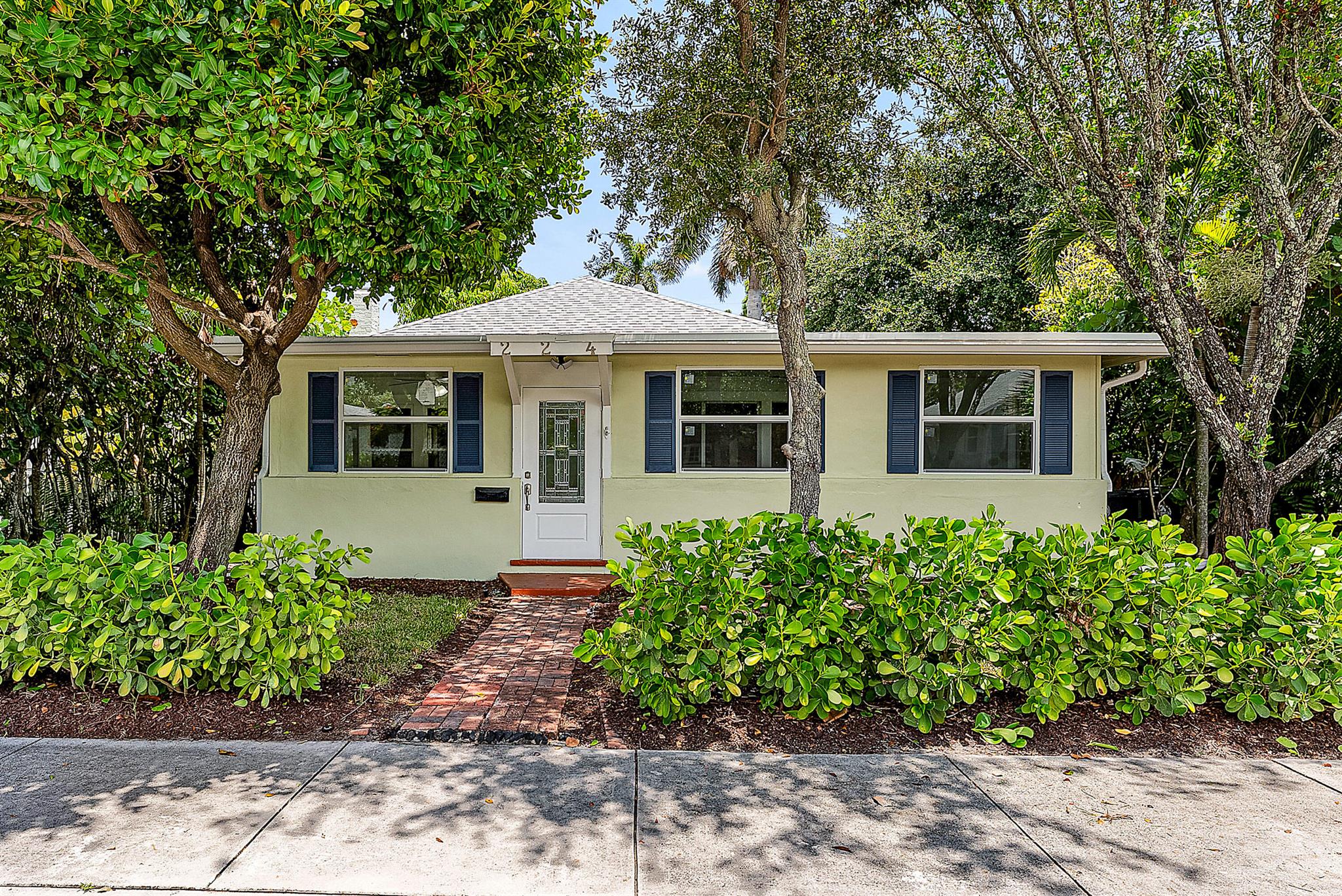 In the heart of downtown Lake Worth's historic district, this meticulously restored 1920s home blends timeless charm with refined modern luxury. Original pine floors in Loba Whitener stain flow through sunlit spaces. The chef's kitchen features custom cabinetry, Fisher & Paykel appliances, Blanco Silgranit sink, and Lyngard lighting. Baths showcase Calacatta Green marble, Zellige tile, and Signature Hardware fixtures. Noir Moon & Bianco Carrara marble entry, terrazzo laundry, and cast-stone fireplace elevate interiors. A detached garage with alley access offers ADU potential, while the deep backyard provides ample room for a pool. Brand-new impact windows complete this rare offering. Minutes to West Palm Beach and PBI Airport for unmatched convenience.