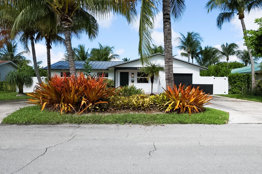Tucked away on a charming, tree-lined street just over a mile from Delray's vibrant Atlantic Avenue, this sun-filled Lake Ida bungalow blends comfort, style, and Florida living at its best. Offering 3 bedrooms and 2 bathrooms across 1,600+ sq ft of living space, the home features a bright enclosed porch, Italian wood-look porcelain tile, updated LED lighting, and a welcoming kitchen with granite countertops and a breakfast bar that flows into open living and dining areas. Impact windows with accordion shutters provide peace of mind, while the oversized laundry room offers flexibility for storage, a home office, or future reimagination.
