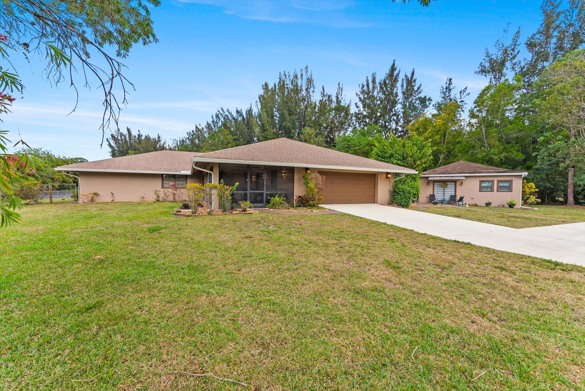 Beautifully remodeled in 2022, this spacious home with a detached guest house sits on an oversized 1.83-acre lot with city water, full fencing, fruit trees, and a solar-powered gate. The main home features a brand-new kitchen, updated bathrooms, new roof, HVAC, plumbing, and electrical, plus durable porcelain tile and luxury vinyl plank flooring. The split floor plan includes a large primary suite with a private office. The in-law suite offers vaulted ceilings, 2019 HVAC, and wood-look tile. Outdoor living shines with a screened-in pool, covered patios, and a large front porch. Located across from a natural preserve with no front neighbors, just steps from a local park. Bonus: the road is currently being paved!