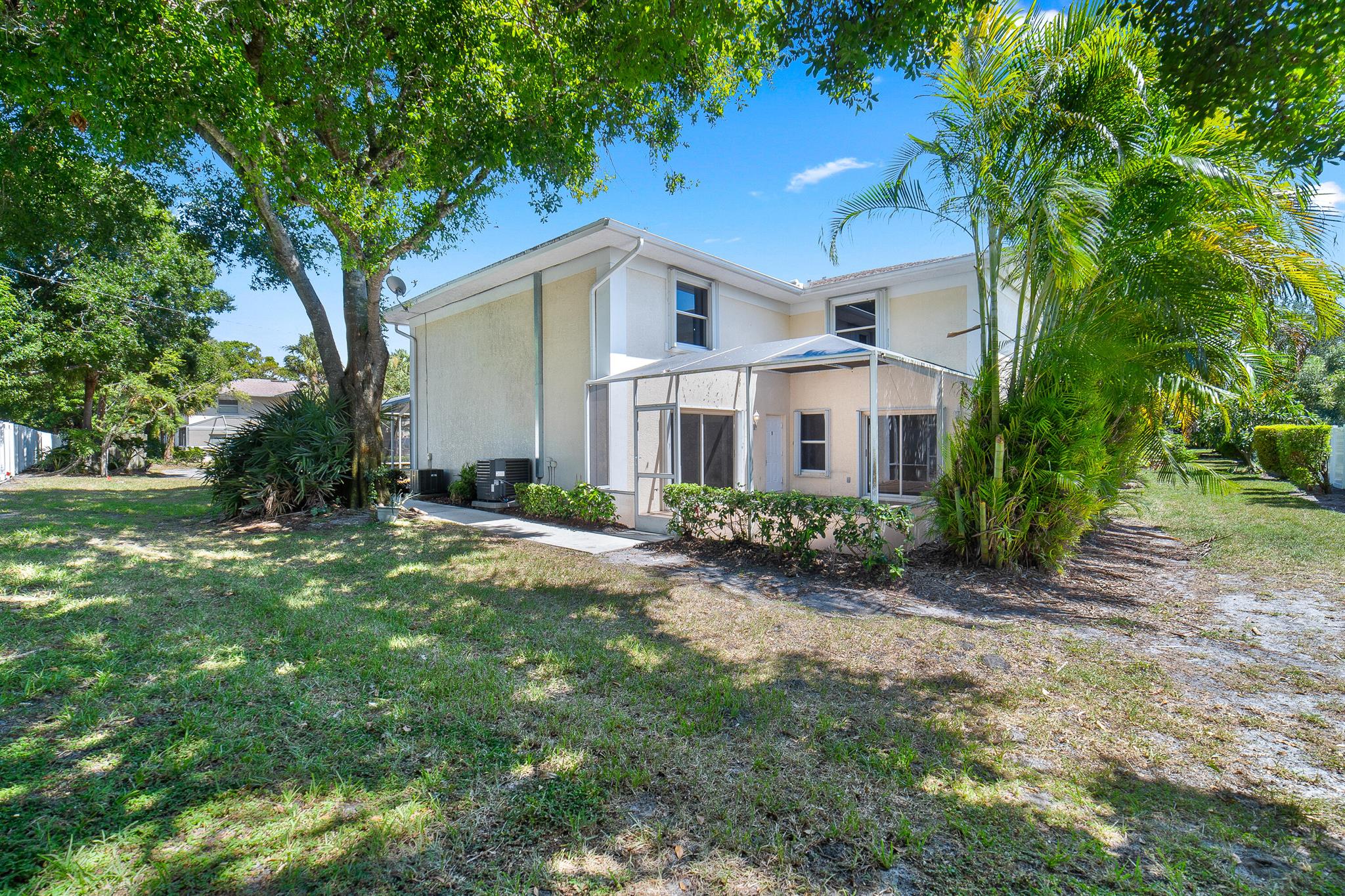 Welcome home to this fantastic 3 bedroom 3 bath opportunity located in the highly sought after Lawnwood community of Fort Pierce. The home boasts a large kitchen with white cabinetry and tons of counter space. The property features one bedroom and bathroom on the first floor for ease of use and large living area. Upstairs, you find two additional large bedrooms with ensuite baths. Newer wood themed flooring in the bedrooms with tile in the living areas. The home offers outstanding outdoor living opportunities with a huge screened patio, perfect for relaxing or entertaining. The home is a corner unit facing a new community pvc fence providing excellent privacy. HWH 2015, A/C 2019, full accordion shutters, 2 assigned parking spaces and large upstairs laundry room round out the highlights.