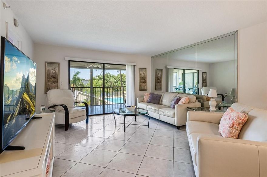 Pristine, Polished Perfection is Yours in this Meticulously Maintained, Waterfront End Unit...Corner Floor Plan has Brand-New Impact Windows All Around for Lots of Light & Sweeping 180-Degree Views. Open Kitchen & Spacious Great Room Offer a Contemporary Ambiance, while the Ample Screened Balcony--Overlooking the Glimmering Lake & Lush Pool Area--Makes the Perfect Spot Whether You're Relaxing or Entertaining. Ceramic Tile & Muted Paint Palette Throughout. Split Bedrooms Afford Greater Privacy. Welcoming Owner's Suite w/Home-Office Nook, Walk-In Closet, & Master Bath w/Large Step-In Shower. In-Unit Washer/Dryer. 1 Pet <20#. $5.3K SPECIAL ASSESSMENT PAID BY SELLER AT CLOSING! Heated Pool/Spa, BBQ, Tiki Bar, Jog Trails, Clubhouse, Pickleball/Tennis, Gym. Near Dining, Casino, Golf, Beach!