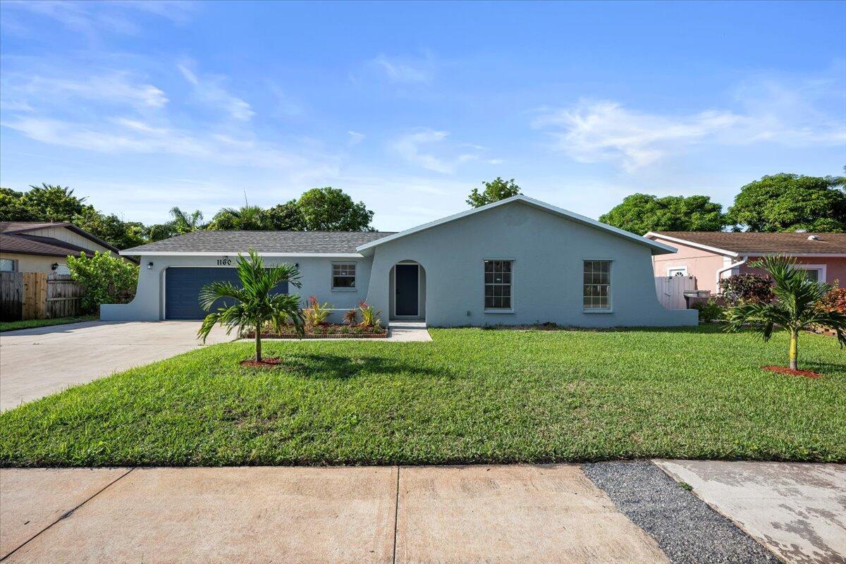 Welcome to this beautifully updated 3 bedroom, 2 bath home with a spacious 2.5-car garage in the heart of West Palm Beach. Featuring a brand-new roof and full impact windows, this property combines peace of mind with modern style. Step inside to discover fresh interior and exterior paint, along with gorgeous new luxury vinyl wood-look waterproof flooring throughout.The brand-new kitchen is a true showstopper, complete with stylish cabinetry, quartz countertops, stainless steel appliances, and designer finishes. Both bathrooms have been fully renovated with stunning details that feel fresh and modern.With ample parking, a large garage, and a move-in-ready interior, this home is perfect for anyone seeking comfort, style, and durability.Don't miss your chance to own this beauty!