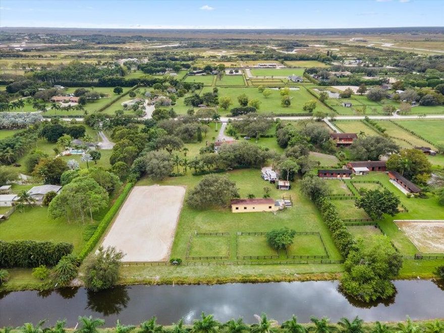 GREAT LOCATION! Charming 4-stall barn featuring a tack room, feed room, wash rack, and picturesque paddocks. Located in the sought-after Rustic Ranches community, you'll enjoy easy access to Horseman's Park, scenic trails, and the renowned Winter Equestrian Festival (WEF).