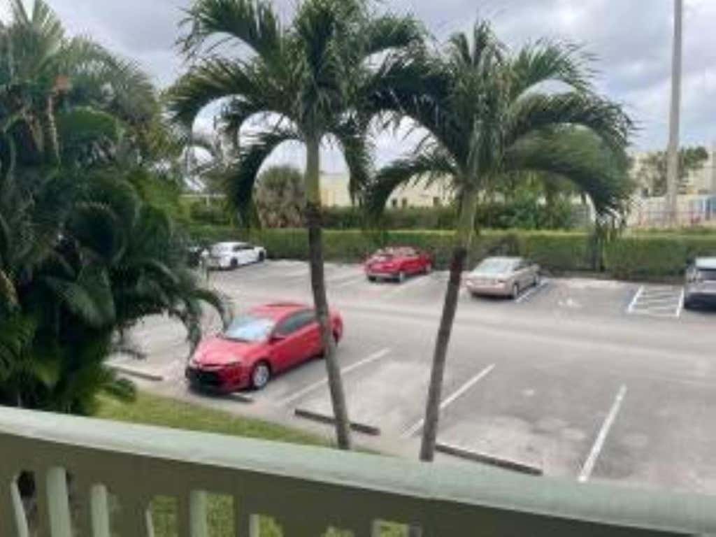 Photo of 400 Village Green Circle W #202, Palm Springs, FL 33461 (MLS # B26061308)