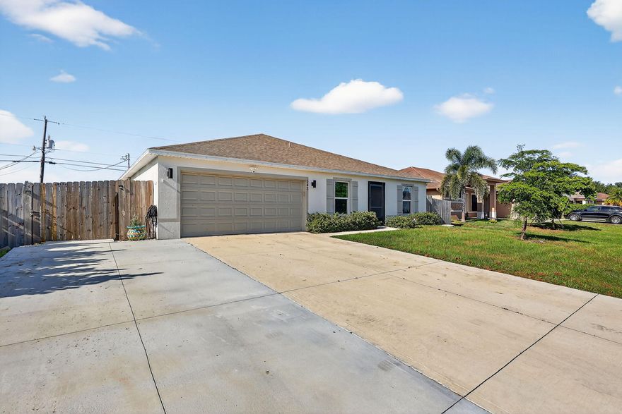 No HOA, Not on a Busy Street!  Better than new! 2023 built 4/2/2 CBS Home. 50k+ of improvements include a 700sft driveway extension that doubles the front drive and extends into the back/side yard for parking your toys. A HUGE 15x47 705sf screened in Patio with Fans and a Bar. Cement Fire pit pad, Fenced Yard, Farmhouse Sink, Upgraded Refrigerator, Wired Ethernet to almost all rooms, Tankless Water heater, Roll down zebra blinds in all rooms, Attic Ladder & 400SF Attic Flooring for storage, Lots of lighting. Located in desirable SW Port St Lucie Close to 95 & Turnpike as well as Newberry/Citrus for Easy commute south. Near Treasure Coast HS & Whispering Pines Park with Racquetball, Pickleball, Tennis, Baseball, Football, Basketball, Skating Rink, Massive Playground. Near shopping.