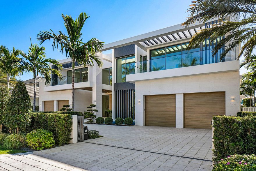 Experience the pinnacle of waterfront luxury in Royal Palm Yacht & Country Club. This extraordinary estate is masterfully crafted by the acclaimed Sarkela Corporation and Ada Architecture Design Atelier. Encompassing over 9,500 square feet of living space, this architectural masterpiece offers six bedrooms, seven full bathrooms, and two half bathrooms, all impeccably designed for unparalleled sophistication and comfort. Every detail of this home reflects the highest level of craftsmanship and quality. The interiors showcase hand-finished DuChateau premium oak hardwood floors, sleek Italian cabinetry, and elegant European marble in the kitchen and baths. Dornbracht bath fixtures and Terzani lighting installations elevate the ambiance, creating an atmosphere of refined elegance.