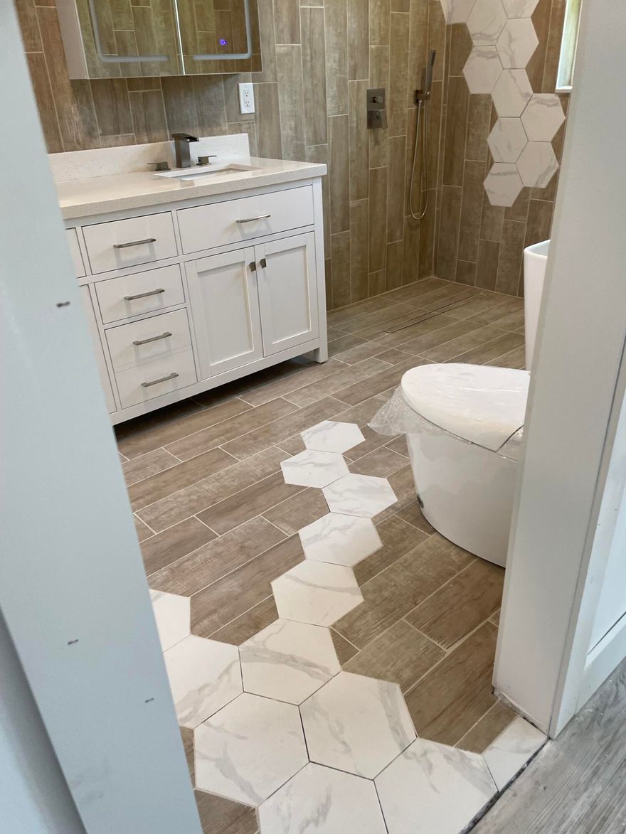 Meticulously refreshed 3-bedroom, 2-bath home on a large lot (10,701 sf) in quiet enclave, just a short distance to premier dining and entertainment. Designed for comfort and efficiency: METAL ROOF (2019) - 8 yrs warranty remaining, A/C (2025), Electric Vehicle charger, upgraded electrical panel, IMPACT windows doors, re-lined sewer pipes, NEW APPLIANCES, tankless water heater, smart toilets, new exterior stucco and reframed windows, flat roof (remaining 3 yrs warranty), new ceilings and drywall, custom closets, and integrated dimmable LED lighting. An expansive screened-in Florida room overlooking a private garden with a Rain Bird irrigation system on well water with plenty of space left for a custom pool. Abundant additional storage, clean ducts, foam insulation, and termite protection. Windows have Zebra Shades and Blackout blinds. Herb Garden in back and carport has herbs growing successfully - Dill, Lemongrass, Oregano, and Tomatoes. New photos taken on Wednesday, Showings Start on Thursday.