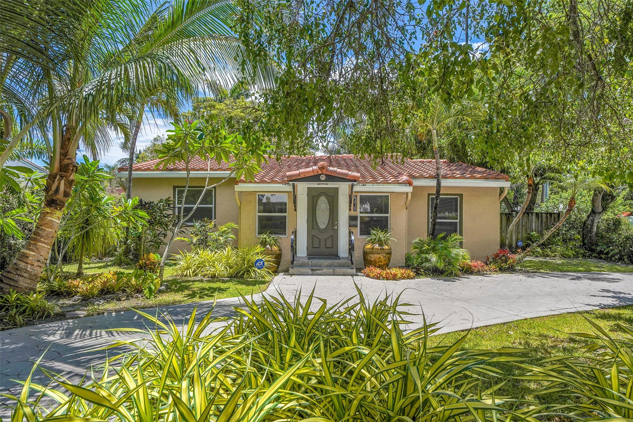 Charming 3 bedroom and 2 1/2 bath home located on a great corner with the most beautiful vegitation and fruit trees! A custom railing invites you to enter this updated treasure that boasts a spacious floorplan! A gourmet kitchen with a gas range, updated bathrooms, an indoor laundry room with wash tub, and so much more that you just have to experience it for yourself. Barrel Tile Glazed Roof 2019, Air Conditioner, 2020, Tankless Hot Water Heater, and Impact Windows and Doors. The backyard boasts a shed for extra storage and a welcoming garden to enjoy the best of South Florida flora and fauna.