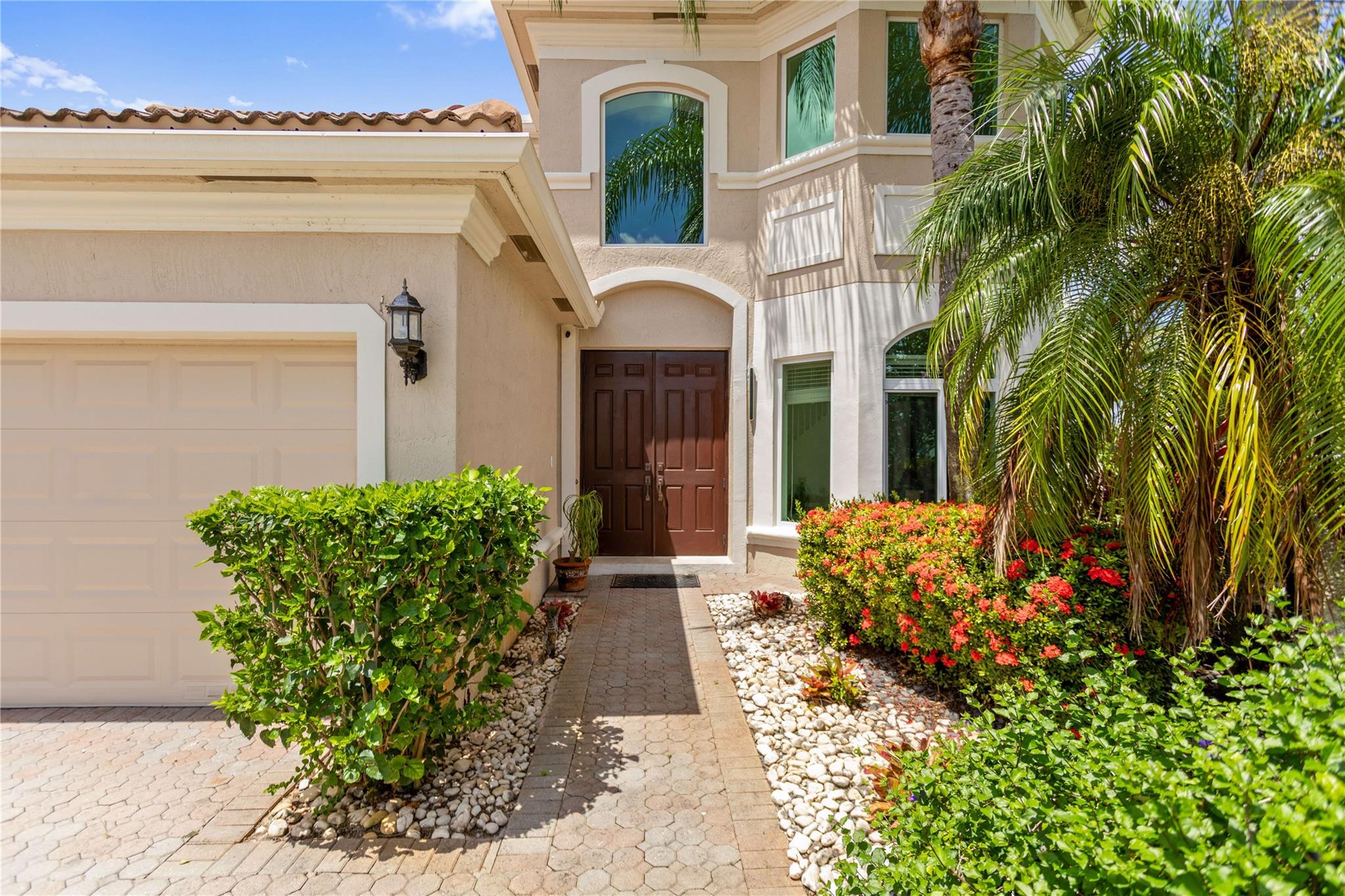 Step into this elegant two-story lakefront residence, perfectly situated in a peaceful cul-de-sac within the prestigious gated community of Laguna Isles. This home offers 4 spacious bedrooms and 2.5 bathrooms. The master suite is on the main floor features hardwood floors, a large bath, soaking tub, and separate shower. Upstairs are 3 bedrooms with hardwood flooring and a full bath. The modern kitchen includes white cabinetry and stainless steel appliances, opening to the family room and breakfast area. Oversized French doors lead to a brick-paved patio overlooking the lake, perfect for relaxing or entertaining while enjoying spectacular sunset views. Features include a large fenced yard, impact windows and doors, and a 2-car garage. Residents enjoy a clubhouse, pool, tennis courts,