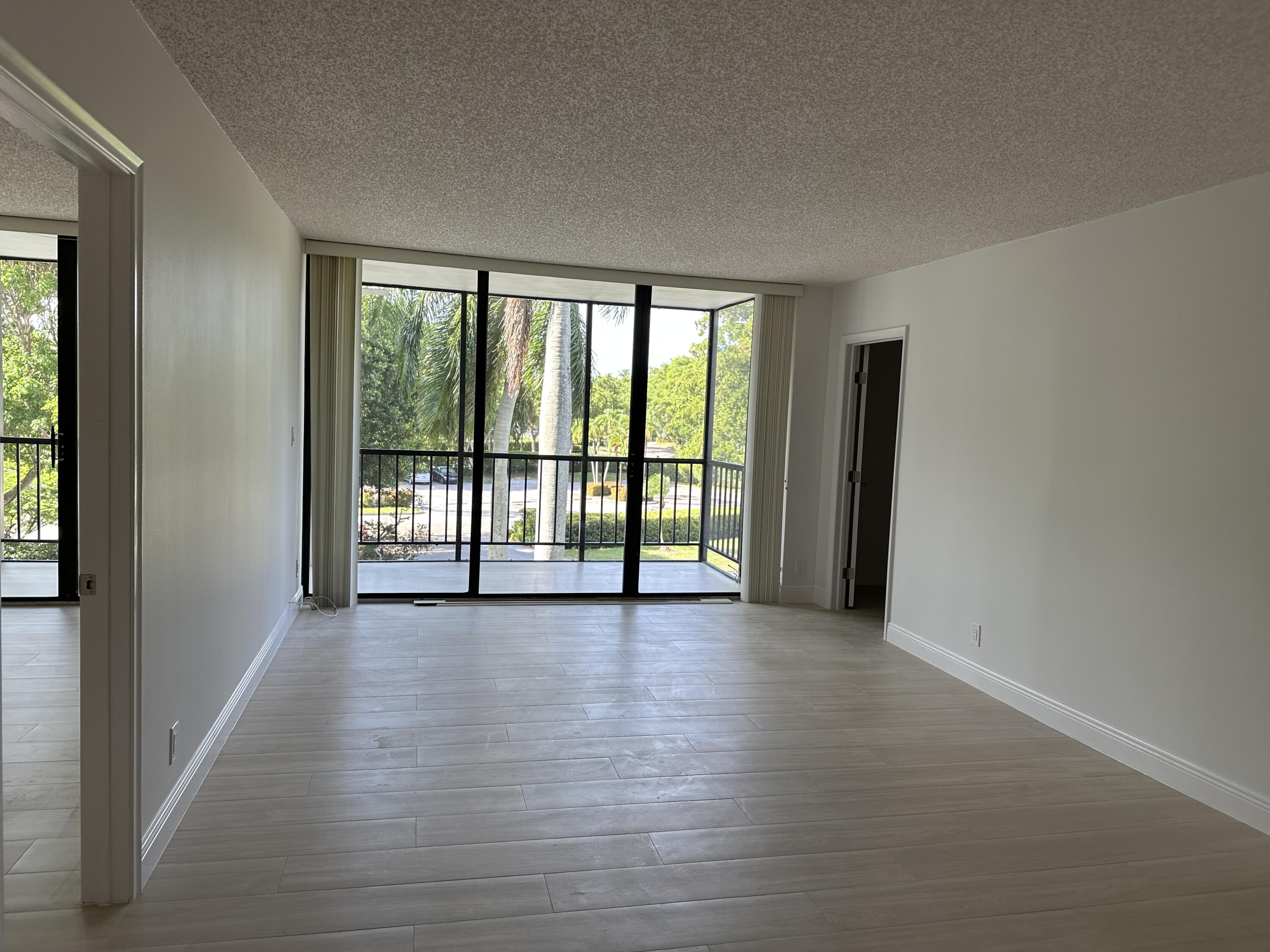 Not your typical midrise corner apartment!This unique residence features a versatile bonus room--perfect for a media room, home office, or cozy den. The kitchen terrace has been thoughtfully enclosed to create a charming dining area. Both bathrooms and flooring have been recently renovated, adding a fresh, modern touch.Enjoy a tree-lined front view for privacy and a picturesque side view overlooking the pool and golf course.