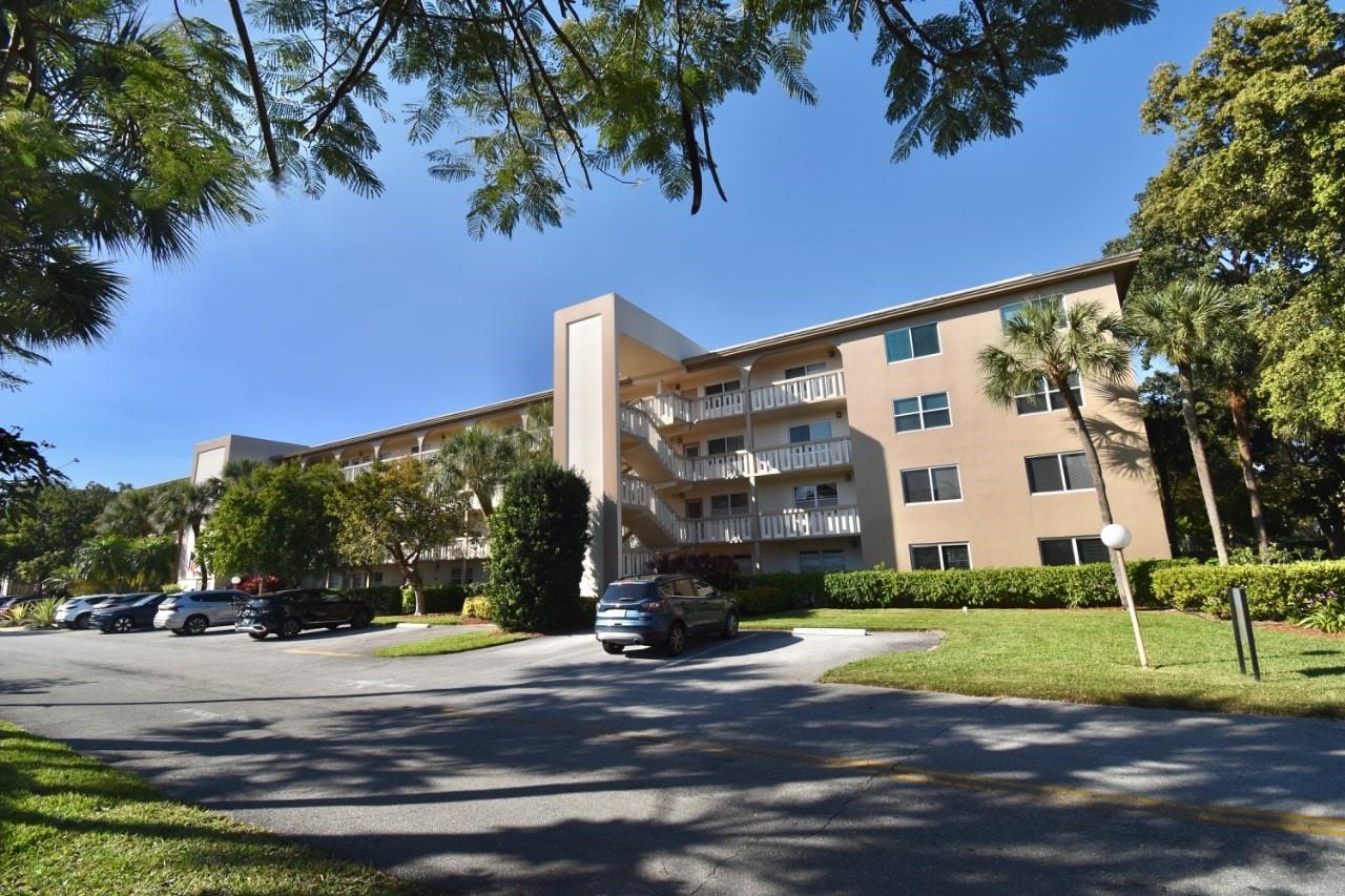 Beautifully remodeled 55+ first floor condo with breathtaking panoramic lake views! The open entry leads to the kitchen with custom cabinets, granite countertops, and stainless steel appliances. Features include 14” diagonal porcelain tile and wood laminate flooring, remodeled bathrooms, a walk-in shower in the guest bath, and a walk-in closet. The impact glass-enclosed lanai is raised and has new windows with no direct sun exposure. Additional upgrades: 5-year-old A/C and roof, newer water heater, Kirsch blinds, and freshly painted interior. Parking by stairs and full-size storage unit included. Walk to the theater, fitness center, jacuzzi, lazy river, main pool, BBQ area, and on-site restaurant. HOA covers water and cable. Ideally located near all essentials for easy living!