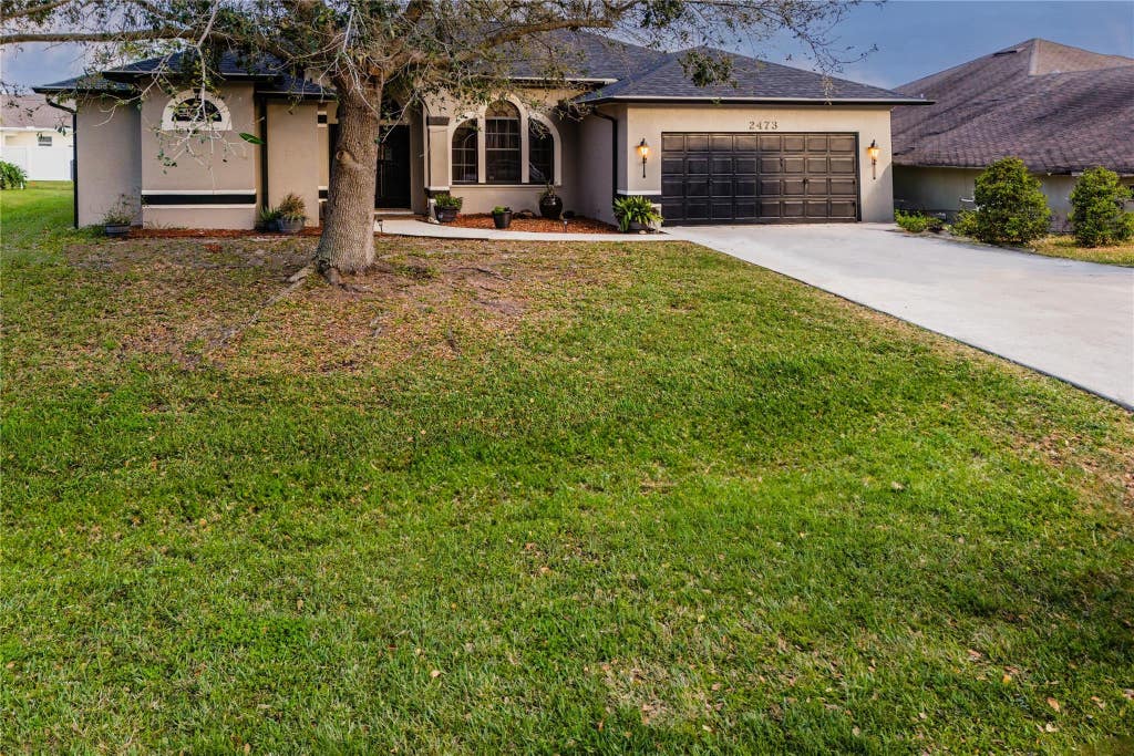 Photo of 2473 SW Mercer Street, Port Saint Lucie, FL 34984 (MLS # F10420450)