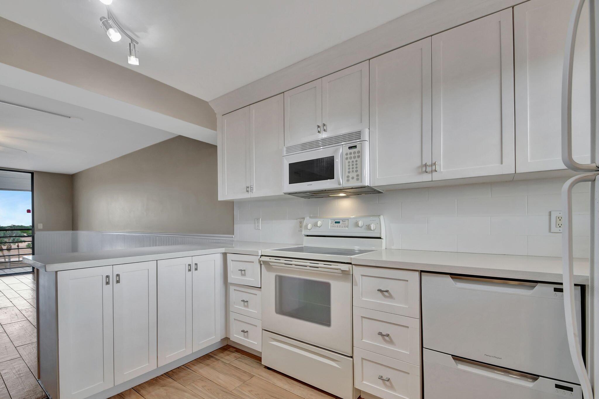 WELCOME TO THIS BEAUTIFUL,PRISTINE UPDATED CONDO WITH BALCONY VIEWS OF THE RESORT STYLE POOL. ENJOY PICKLEBALL,TENNIS,SHOWS, EXERCISE ROOM,COURTESY BUS, & 2 POOLS! RELAX BECAUSE THE WORK IS DONE! KITCHEN CABINETRY,QUARTZ COUNTERTOPS, CROWN MOLDING,, AN OPEN FLOORPLAN. BATHROOM VANITIES WITH QUARTZ COUNTERTOPS & AN ATTRACTIVE WALK-IN SHOWER IN THE MASTER BEDROOM. MATCHING WOOD-LOOK TILE THROUGHOUT! THE CONDO FEE INCLUDES WATER,MASTER INSURANCE & EXTERIOR MAINTENANCE, & Bluestream TV. MINUTES TO THE TURNPIKE, SHOPPING, WELLINGTON MALL & APPROXIMATELY 8 MILES TO THE BEACH! 55+AGE COMMUNITY.