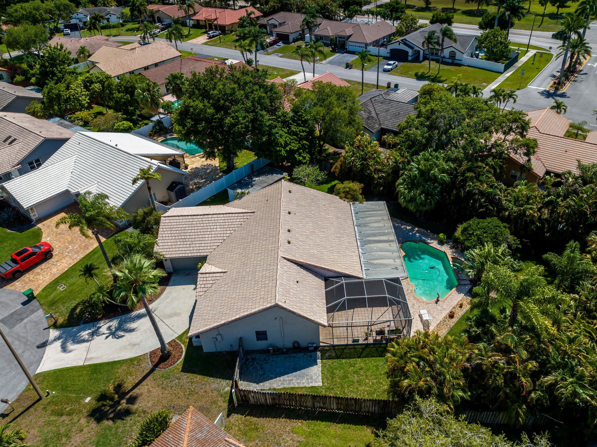 Discover your dream home nestled at the end of a tranquil cul-de-sac. This exceptional property boasts over 1/3 acre, (16,763 SF) offering a retreat-like setting with unparalleled privacy. One of the standout features of this residence is the expansive 20X60 screened patio overlooking the open pool area. A perfect space for both relaxation and entertainment, it seamlessly blends indoor & outdoor living. Here, you’ll find yourself surrounded by lush tropical landscaping, providing a serene backdrop for morning coffees or evening gatherings. Inside you’re greeted by a New Sleek Modern Kitchen with 42" Cabinetry, Granite Counters & New Appliances. This popular model offers a split floor plan, formal living & dining rooms and a large family room. The 2Car Garage is air-conditioned.