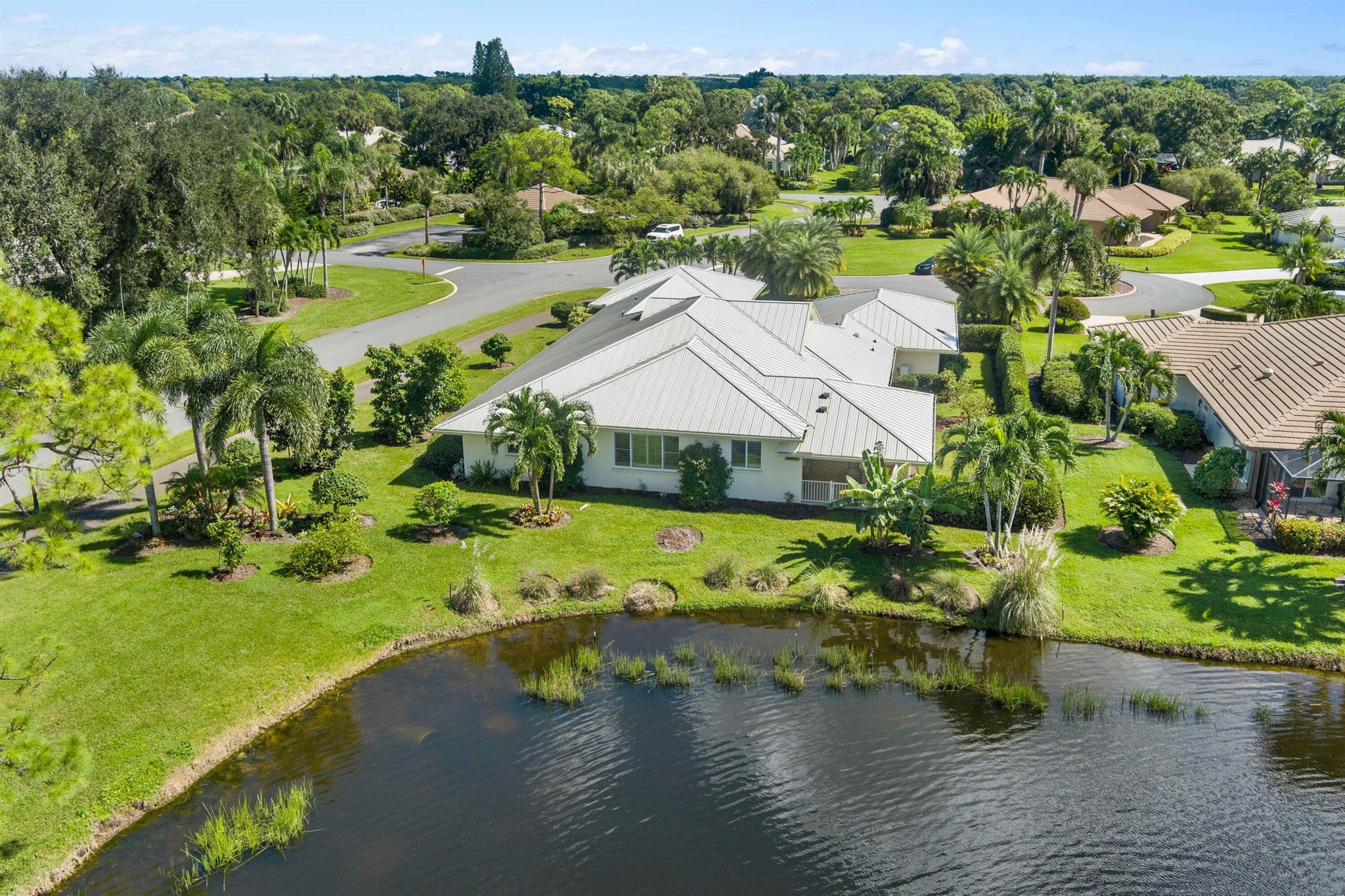 Welcome to this stunning fully renovated and expanded 3-bedroom, 3.5-bath home with an office (easily convertible into a 4th bedroom) and a 3.5-car garage, ideally located on a peaceful .45-acre lot within the prestigious gated community of Piper's Landing Yacht & Country Club in Palm City.This home offers 3,753 sq ft of luxurious living space, completely reimagined with the highest quality materials and craftsmanship.Inside, you'll immediately notice the bright open layout, raised ceilings, and seamless flow between the living, dining, and kitchen areas. The gourmet kitchen features granite countertops, custom cabinetry, Thermador appliances, a walk-in pantry, and an extended island perfect for entertaining.