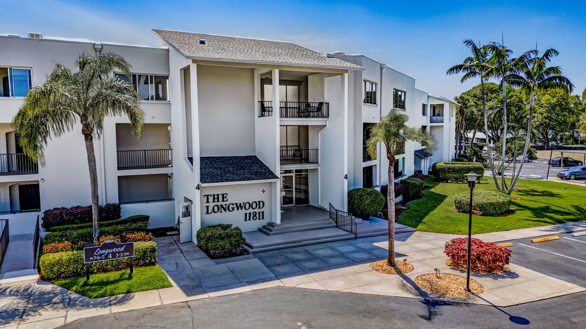 LIGHT AND SPACIOUS, FIRST FLOOR CORNER UNIT IN POPULAR 55+ COMMUNITY OF LONGWOOD. COVERED AND SCREENED WRAP AROUND PATIO WITH VIEWS OF POOL AND LAGOON. UPDATED KITCHEN WITH HIGH END STAINLESS STEEL APPLIANCES, INCLUDING CONVECTION OVEN, OPEN TO DINING AND EXPANSIVE LIVING ROOM. NEUTRAL TILE FLOORS THROUGHOUT. WASHER AND DRYER INSIDE UNIT. BLINDS ON REMOTE AND BEAUTIFUL CUSTOM DRAPES. JETTED TUB IN PRIMARY BATH. LARGE STORAGE UNIT, COVERED DEEDED PARKING #24. LONGWOOD HAS BEEN COMPLETELY RENOVATED WITH NEW ROOFS. FRESHLY PAINTED. PERFECT LOCATION JUST OFF PGA BOULEVARD. GREAT DINING, SOME WITHIN WALKING DISTANCE AND CLOSE TO GOLF, MARINAS, BEACHES AND SHOPPING, INCLUDING THE GARDENS MALL. MINUTES TO PBI OR THE KRAVIS CENTER AND DOWNTOWN WEST PALM BEACH.