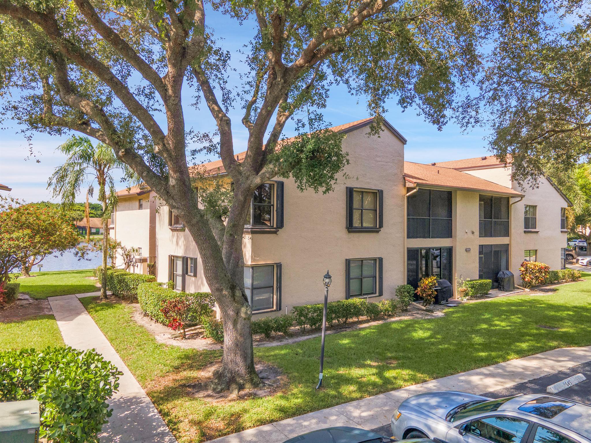 Welcome to this spacious 3 bedroom, 2 bathroom condo located in a quiet, gated community. The open concept living and dining area is filled with natural light and flows seamlessly onto a huge screened balcony - perfect for relaxing or entertaining while overlooking the lush garden. The home features accordion hurricane shutters on all windows and balcony for year-round protection. The primary suite includes a walk-in closet and a private en-suite bathroom while the two additional bedrooms offer flexibility for family, guest, or a home office. Enjoy the convenience of in-unit laundry and dedicated parking in front of the building. Community amenities include 2 pools, fitness room, clubhouse, tennis courts and walking trails, all within the safety and privacy of a secure environment.
