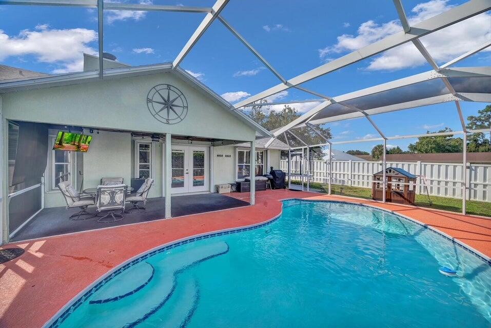 LOCATION, LOCATION, LOCATION! This impeccably updated 4 bedroom plus a den/office, 2 bathroom POOL home is located within 5 minutes of I-95, Walmart, Home Depot, Tradition, St. Lucie West and less than 40 minutes to Palm Beach Gardens! Situated on a corner lot with no HOA. The kitchen features SS Appliances, Oversized Island with seating plus room for a kitchen table. The primary suite is your own private retreat including double vanities and custom walk-in. Enjoy the outdoors year around with screened in lanai and pool. Pool service is included with rent. This home is situated on a corner lot and pets are welcome and have a fenced in yard to roam. Accordion shutters & LG Washer/Dryer. This home is immaculate and not your typical rental and before you rent you must see this home first!